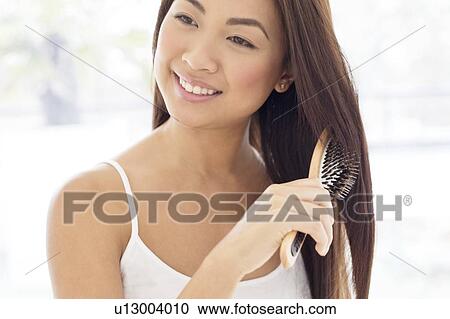 Woman brushing hair View Large Photo Image Stock Image - Woman brushing hair. Fotosearch