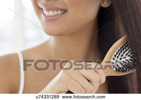 Stock Photo - Woman brushing hair. Fotosearch