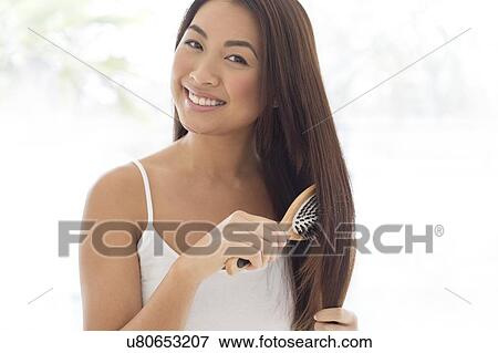 Woman brushing hair View Large Photo Image Stock Photo - Woman brushing hair. Fotosearch