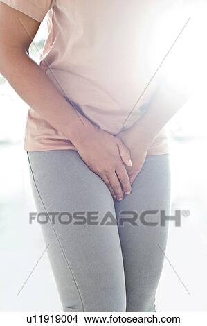 Picture - Woman clutching stomach in pain. Fotosearch