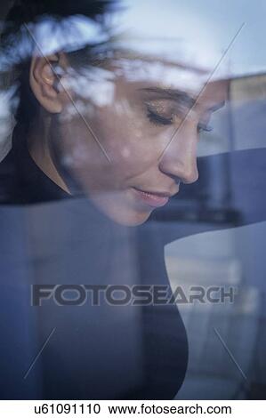 Stock Image - Woman day dreaming. Fotosearch