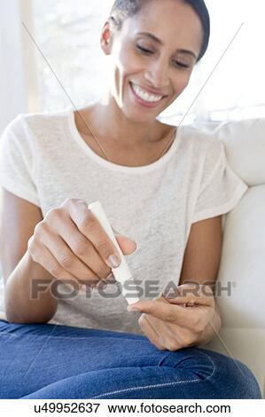 Woman doing pin prick test on finger View Large Photo Image Stock Photo - Woman doing pin prick test on finger. Fotosearch