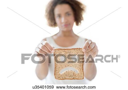 Woman holding bread with sad face View Large Photo Image Stock Photo - Woman holding bread with sad face. Fotosearch