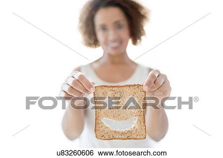 Woman holding bread with smiley face View Large Photo Image Stock Photograph - Woman holding bread with smiley face. Fotosearch