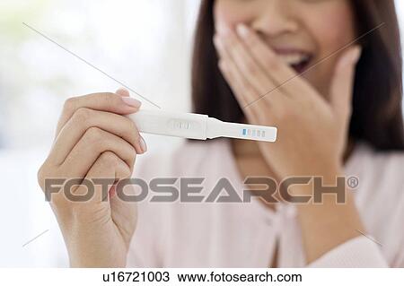 Woman holding pregnancy test View Large Photo Image Stock Image - Woman holding pregnancy test. Fotosearch