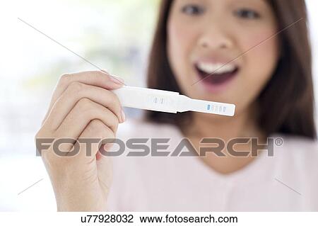 Woman holding pregnancy test View Large Photo Image Stock Image - Woman holding pregnancy test. Fotosearch