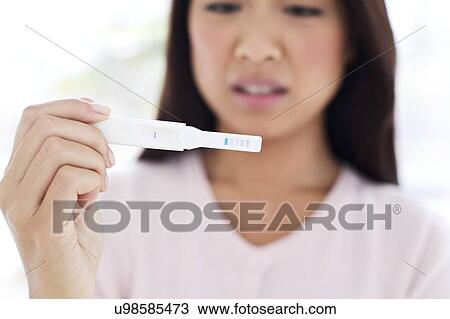 Woman holding pregnancy test View Large Photo Image Stock Image - Woman holding pregnancy test. Fotosearch