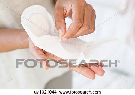 Picture - Woman holding sanitary towel. Fotosearch