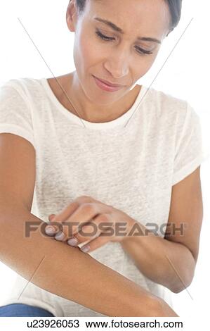 Stock Image - Woman scratching arm. Fotosearch