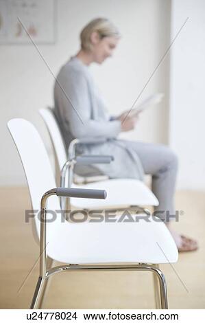 Woman sitting in doctor's waiting room View Large Photo Image Picture - Woman sitting in doctor's waiting room. Fotosearch