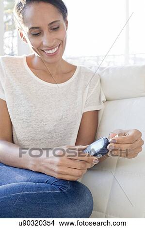Woman testing blood glucose View Large Photo Image Picture - Woman testing blood glucose. Fotosearch