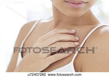 Woman touching chest View Large Photo Image Stock Image - Woman touching chest. Fotosearch