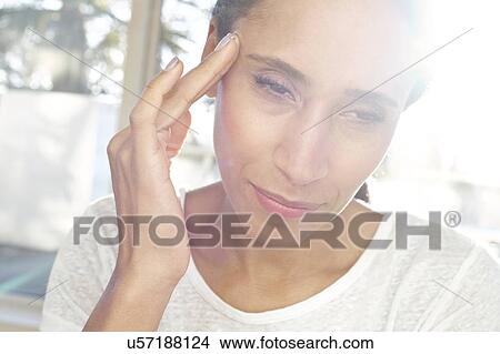 Picture - Woman touching face in pain. Fotosearch