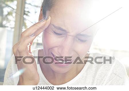 Stock Image - Woman touching face in pain. Fotosearch