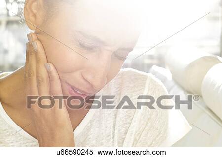 Woman touching face in pain View Large Photo Image Stock Photography - Woman touching face in pain. Fotosearch