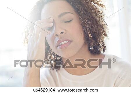 Picture - Woman touching her face. Fotosearch