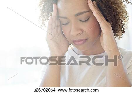 Woman touching her head View Large Photo Image Picture - Woman touching her head. Fotosearch