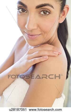 Stock Image - Woman touching shoulder. Fotosearch