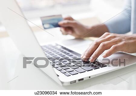 Woman using credit card and laptop View Large Photo Image Picture - Woman using credit card and laptop. Fotosearch