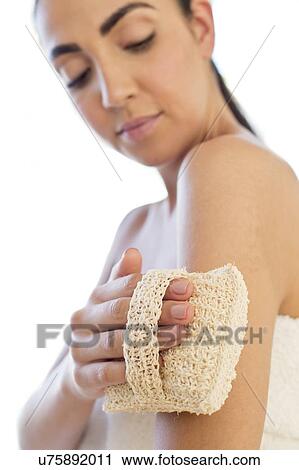 Woman using loofah mitt on arm View Large Photo Image Stock Image - Woman using loofah mitt on arm. Fotosearch