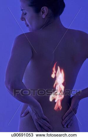 Stock Image - Woman with back pain, conceptual image. Fotosearch