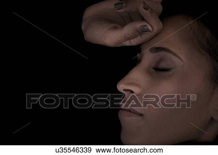Stock Photo - Woman with eye closed. Fotosearch