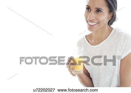 Woman with glass of orange juice View Large Photo Image Stock Photo - Woman with glass of orange juice. Fotosearch