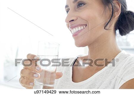 Woman with glass of water View Large Photo Image Stock Photo - Woman with glass of water. Fotosearch
