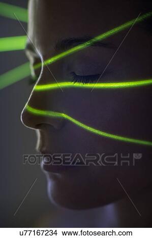 Woman with green lights on face View Large Photo Image Picture - Woman with green lights on face. Fotosearch