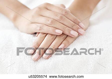 Picture - Woman with hands resting on white towel. Fotosearch
