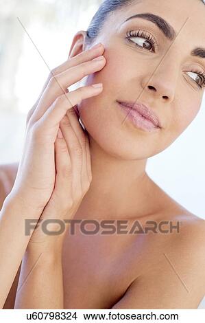 Woman with hands touching face View Large Photo Image Picture - Woman with hands touching face. Fotosearch