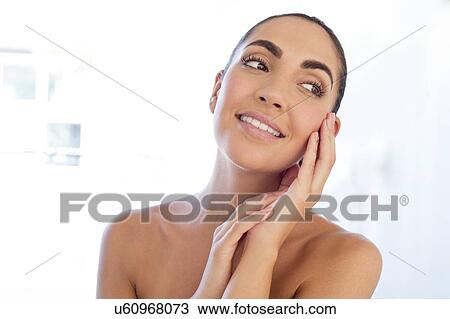 Woman with hands touching face View Large Photo Image Stock Image - Woman with hands touching face. Fotosearch