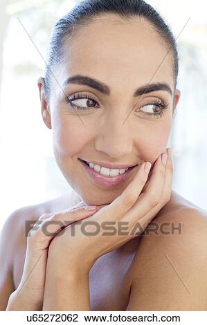 Woman with hands touching face View Large Photo Image Stock Image - Woman with hands touching face. Fotosearch