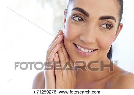 Woman with hands touching face View Large Photo Image Stock Photograph - Woman with hands touching face. Fotosearch