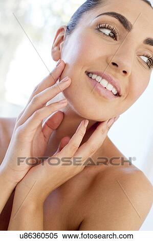 Woman with hands touching face View Large Photo Image Stock Photography - Woman with hands touching face. Fotosearch