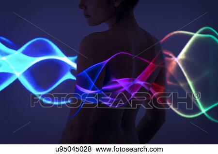 Stock Photo - Woman with multicoloured lights on body. Fotosearch