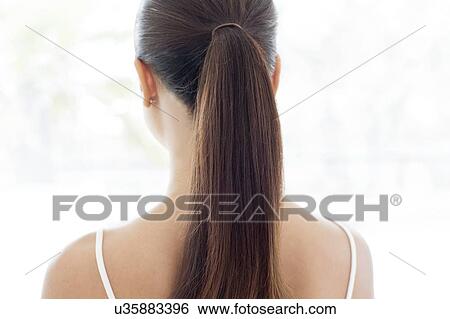 Stock Photograph - Woman with pony tail, rear view. Fotosearch
