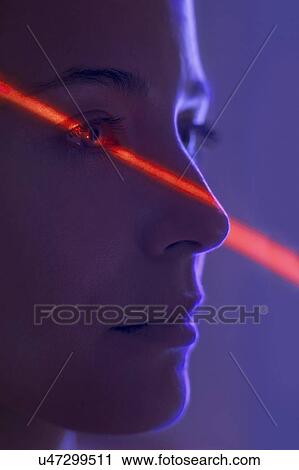 Stock Image - Woman with red light on face. Fotosearch