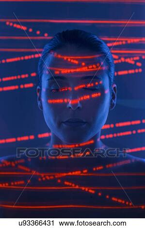 Stock Image - Woman with red lights on face. Fotosearch