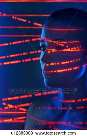 Woman with red lights on face View Large Photo Image Stock Photo - Woman with red lights on face. Fotosearch
