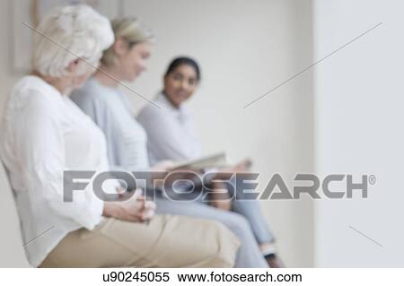 Women sitting in doctor's waiting room View Large Photo Image Stock Photography - Women sitting in doctor's waiting room. Fotosearch