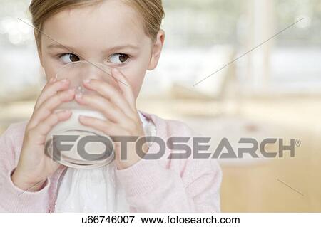 Young girl drinking glass of milk View Large Photo Image Stock Photo - Young girl drinking glass of milk. Fotosearch