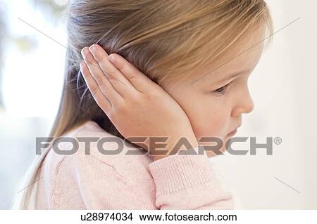 Picture - Young girl with ear ache. Fotosearch