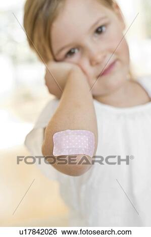 Young girl with plaster on elbow View Large Photo Image Stock Photograph - Young girl with plaster on elbow. Fotosearch