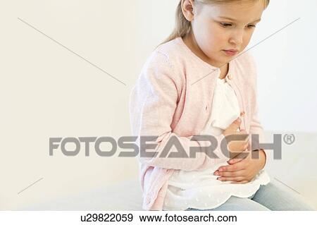 Stock Photo - Young girl with tummy ache. Fotosearch