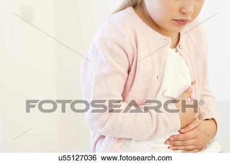Stock Photograph - Young girl with tummy ache. Fotosearch