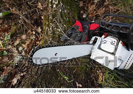 Chainsaw and gloves View Large Photo Image Stock Image - Chainsaw and gloves. Fotosearch