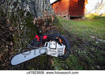 Stock Photo - Chainsaw and gloves. Fotosearch