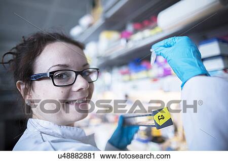 Stock Image - Female scientist in laboratory. Fotosearch