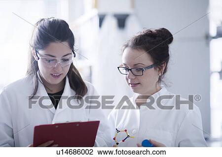 Stock Image - Female scientists in laboratory. Fotosearch